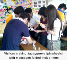 Visitors making kazaguruma [pinwheels] with messages folded inside them